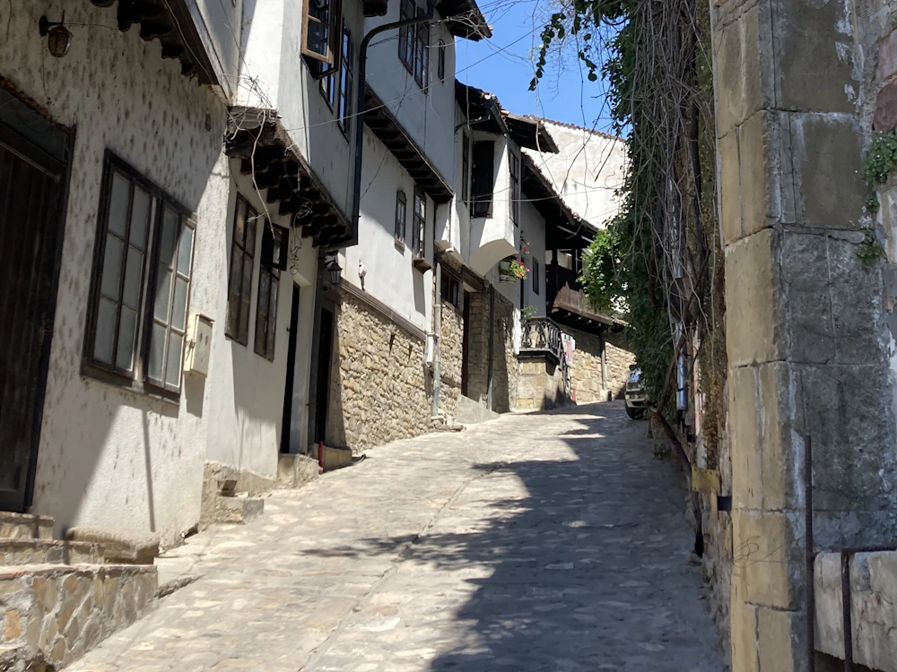 Cobbled old-town street with traditional buildings in Veliko Tarnovo, Bulgaria